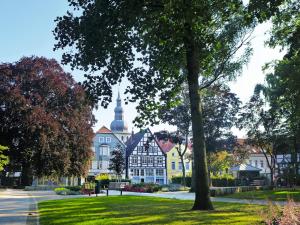 a large building in a park with trees and grass at Best Western Hotel Lippstadt in Lippstadt