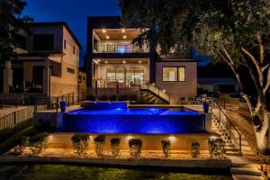 a house with a large pool with blue lights at Lakeshore Retreat with Concierge Services in Kingsland