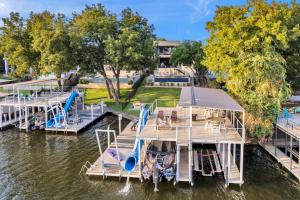 a dock with a water slide and a playground at Lakeshore Retreat with Concierge Services in Kingsland