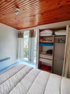 a bedroom with a bed and a wooden ceiling at Nid du Sédour, Havre de Paix en Montagne ! in Arignac