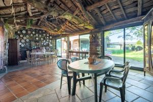 a dining room with a table and chairs at Casa Da Puza in Forcarei
