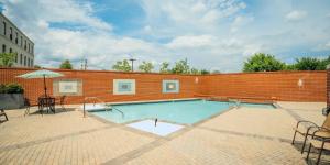 a large swimming pool with a brick wall at Landing at Perry Street Lofts - 2 Bedrooms in Petersburg in Petersburg