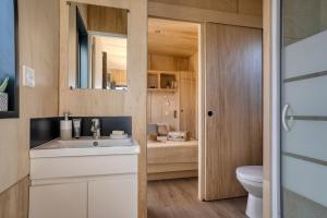 a bathroom with a sink and a toilet at Slow Village Breizh Légendes in Plounéour-Trez