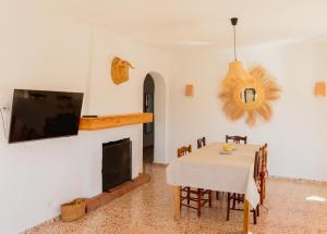a dining room with a table and a fireplace at La Renda Mediterranean Villa - Beach, Jávea Port and amenities within walking distance in Jávea