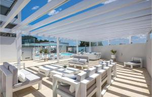 a patio with white furniture and a swimming pool at Lalic Gallery Villa in Bibinje
