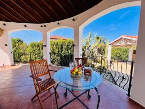 a table with a bowl of fruit on a patio at Villa Rosa by HolidayKeys in Kyrenia
