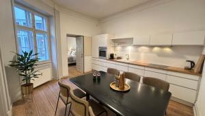 a kitchen with a table and chairs in a room at The Admirals Apartments 1 & 2 in Copenhagen