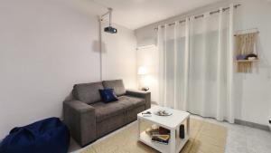 a living room with a couch and a table at The Whale Beach House in Atouguia da Baleia