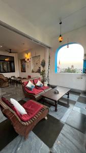 a living room with couches and a large window at Suri Guest House in Pushkar