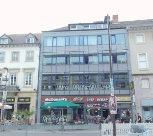 a large building with a cafe in front of it at Street View Apartment - 2SZ - 1WC - 1DU - 1Kü in Karlsruhe