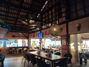a dining room with tables and chairs in a restaurant at Coral Beach Club in Matabungkay