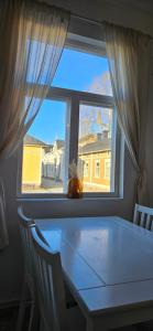 a table in a room with a window at Ilona Vanha Rauma in Rauma