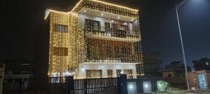 a tall building with lights on it at night at BJ Villa in Mohali