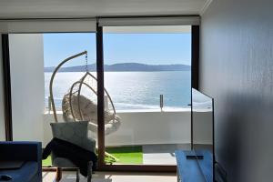 a room with a view of the ocean through a window at Departamentos con hermosas vistas al mar in Coquimbo