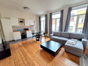 a living room with a couch and a table at La Suite Alice in Brussels