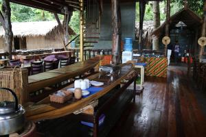 a room with tables and chairs in a building at Borneo Natural Sukau Bilit Resort in Bilit +55 photos