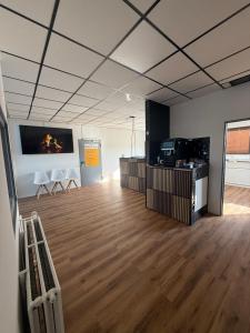 a large room with a wooden floor and a tv at ENSAS rooms in Koblenz