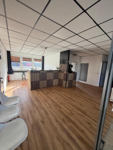 an empty room with desks and chairs in an office at ENSAS rooms in Koblenz
