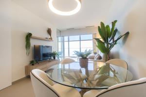 jadalnia ze szklanym stołem i krzesłami w obiekcie Intempo by Holuxe - 203 - 20th Floor w mieście Benidorm