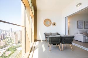 salon ze stołem, krzesłami i kanapą w obiekcie Intempo by Holuxe - 203 - 20th Floor w mieście Benidorm +26 zdjęć