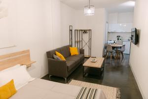 a living room with a couch and a table at MAGNOLIA SUITES in Nafpaktos