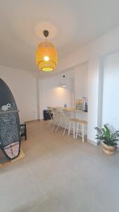 a living room with a table and chairs and a chandelier at The Wave Temple II in Las Palmas de Gran Canaria