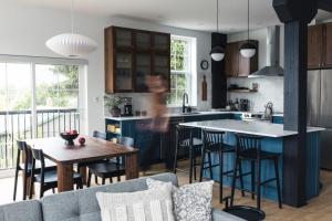 a kitchen with a couch and a kitchen with a table at Lokis Loft and Cellar at the 1896 Building in Kaslo