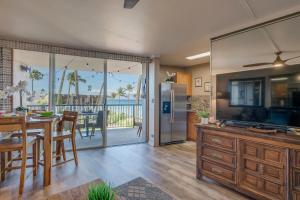 Una cocina y un comedor con una mesa y un refrigerador. en Hale Ono Loa 401, en Kahana 20 fotos más