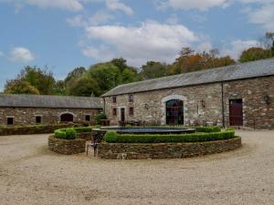 an old stone building with a fountain in front of it at Ballybeg Pod 6 in Arklow