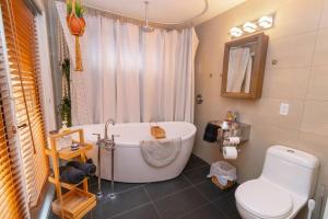 a bathroom with a white tub and a toilet at Cozy Cabin Retreat Hot Tub and Fire Pit in Innisfil +29 photos