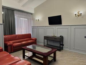 a living room with a couch and a tv at Aqvium in Dnipro