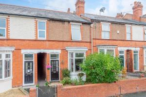 a row of red brick houses with white windows at Monet's in Telford