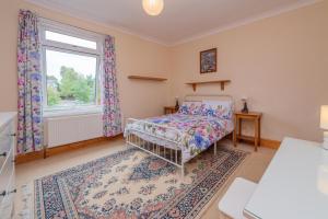 a bedroom with a bed and a window at Monet's in Telford
