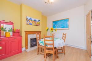 a dining room with a table and a fireplace at Monet's in Telford
