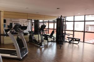 a gym with treadmills and ellipticals in a building at Destino Floripa Jurerê Beach Village in Florianópolis