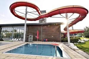 a pool with a slide and a swimming pool at FamilyVilla, new 4 Luxury Big Apartments, parking in Prague