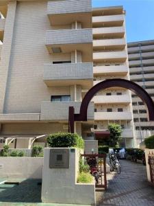 a large apartment building with a sign in front of it at JKhouse4 in Fukuoka