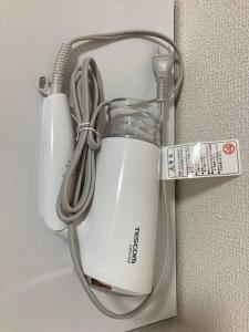a white blender hanging on a wall with a measuring tape at JKhouse4 in Fukuoka