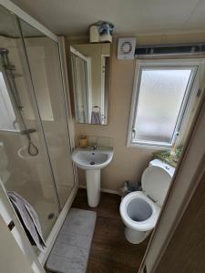 a small bathroom with a toilet and a sink at The Shutt's Escapes - Tattershall Lakes in Tattershall +19 photos