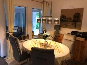 a dining room with a table and two chairs at Ferienhaus Am Eichenberg Haus 3 in Blankenburg