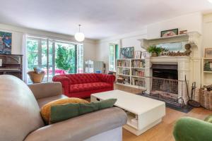 a living room with a couch and a fireplace at Finca La Machota Centro de Naturaleza in Peralejo