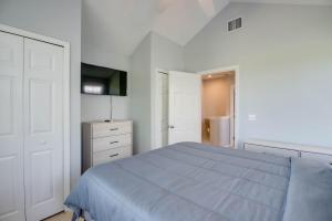 a white bedroom with a blue bed and a closet at Cabana at the Golf Club - Monthly Rental in Key West +24 photos