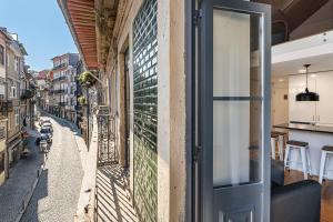 a door to a building with a view of a street at GuestReady - Charming Mezzanine near Porto in Bandeira