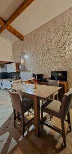 a wooden table and chairs in a kitchen at Duplex Love Room & Spa in Tourves