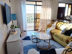 a living room with a couch and a table at Zen Residence in Mombasa