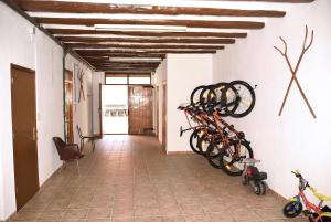 a hallway with bikes hanging on the wall at Can Teixidó in Arbeca
