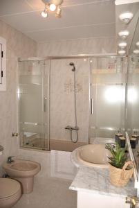 a bathroom with a shower and a toilet and a tub at Can Teixidó in Arbeca