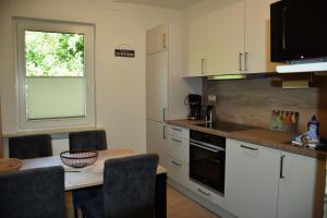 a kitchen with a table and a counter top at Strandkiesel in Büsum