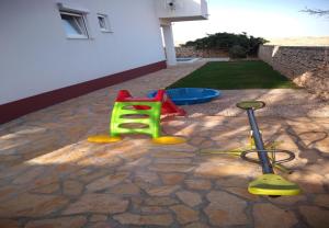a pretend playground with a mop and a stroller at House Dali in Ražanac