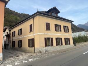 a large yellow building on the side of a street at Mansarda Renten in San Vittore +4 photos